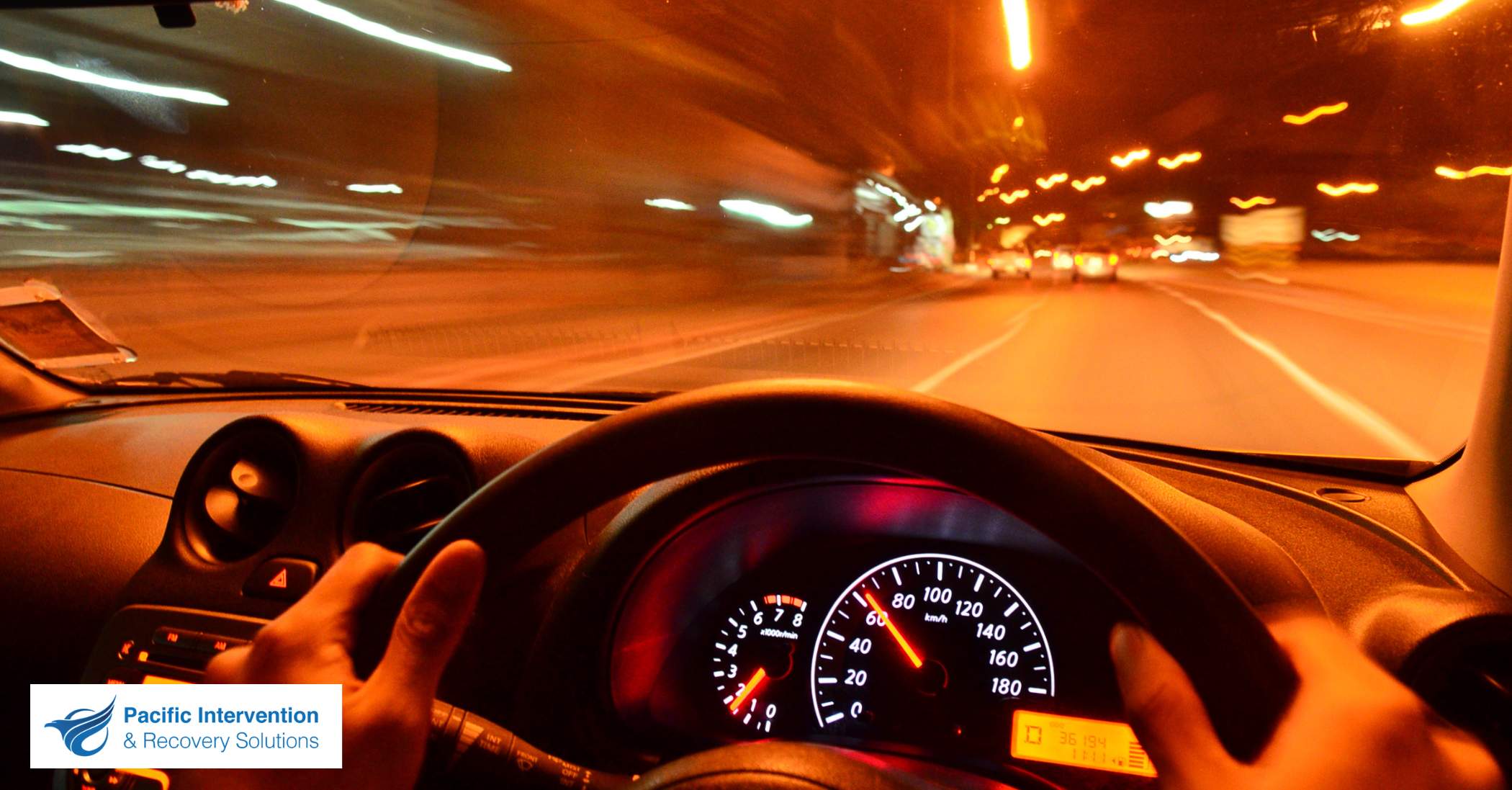Car swerving on a road at night